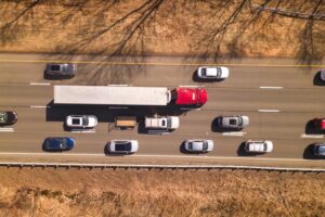 A truck drives around cars on the highway. How can truck accidents be prevented?