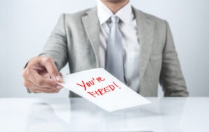 An employee considers calling an Emeryville wrongful termination lawyer after the employer holds out a piece of paper that reads ‘you’re fired.’