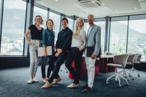 Group of smiling employees after winning sexual harassment case.