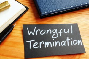 A note card reads ‘wrongful termination.’ Hire a Westchester wrongful termination lawyer now.