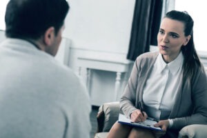 A woman sits at her lawyer’s desk and asks him about the age of consent in California.