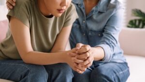 Parent holds hands with child and wonders what the effects of child sexual abuse are.