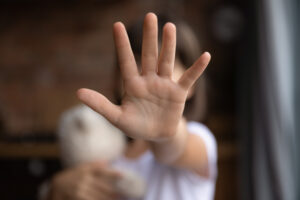 A child’s outstretched hand, representing what CANRA is as it pertains to child sexual abuse